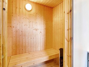 A wooden sauna with a bench and a circular light fixture on the ceiling. - 4 Star Holiday Home in Brenderup Fyn (Middelfart)