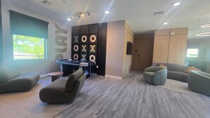 A modern room with a play area, comfortable seating, and a large window. - 3 bedrooms house 12 minutes to Disney (Kissimmee)
