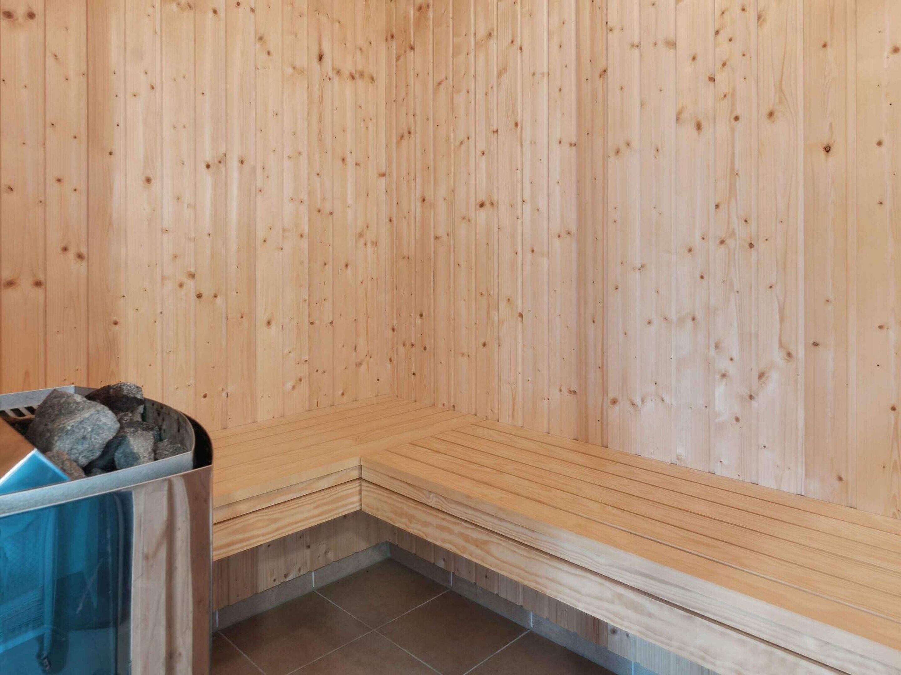 A sauna room with wooden walls and benches.