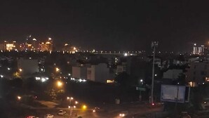 A nighttime view of a roundabout with a central gazebo, surrounded by palm trees and streetlights. - Luxury Rooms In Lucknow (Lucknow)