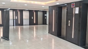 A modern elevator area with metallic walls and a polished floor. - Luxury Rooms In Lucknow (Lucknow)