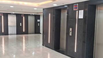 A modern elevator area with metallic walls and a polished floor.