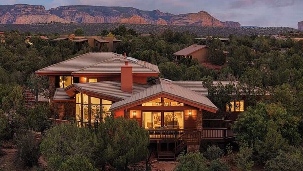 A large, two-story house with a prominent chimney, large windows, and a deck. - Luxury by Nature - Sedona Designer Retreat (Sedona)