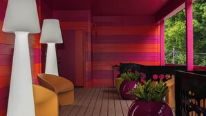 A covered outdoor seating area with wooden flooring, white and yellow chairs, and large potted plants. - Hotel Hilo - Room 102 (Louisville)