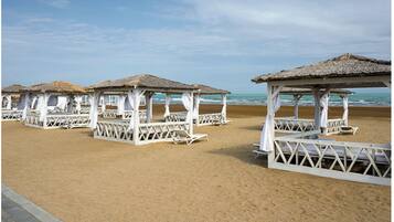 Private beach, black sand, free beach shuttle, beach umbrellas