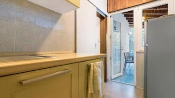 Una cucina con mobili in legno, un piano di lavoro e un frigorifero.