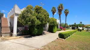 A residential property with a paved driveway, a gated entrance, and a well-maintained lawn. - Typical House with private pool (Siracusa)