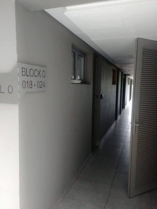 A corridor with a sign reading "BLOCK D 018-024".