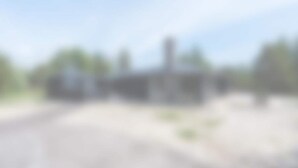 A building with a flat roof, a visible chimney, and a paved ground. - 5 Star Holiday Home in Aakirkeby (Akirkeby)