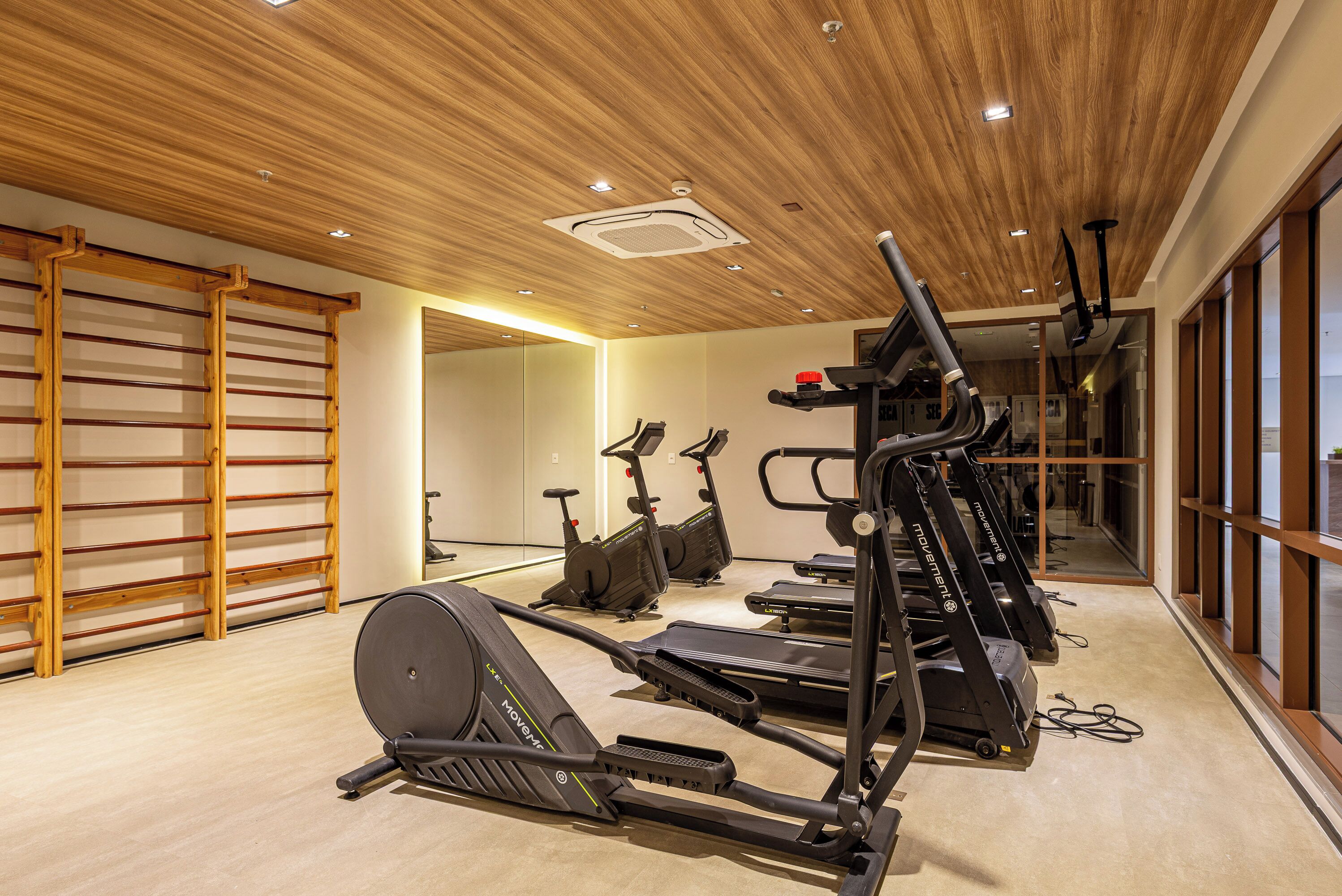 A gym with treadmills, stationary bikes, and a rowing machine.