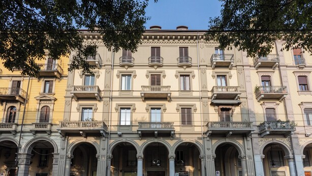 A multi-story building with a classical architectural style, featuring arched doorways and balconies. - Casa Sacchi nei pressi di Porta Nuova by Wonderful Italy (Turin)