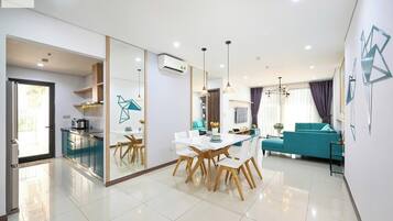 Departamento Deluxe, 2 habitaciones, para no fumadores, vista a la ciudad | Área de sala de estar | Televisión de 24 pulgadas con canales digitales y libros