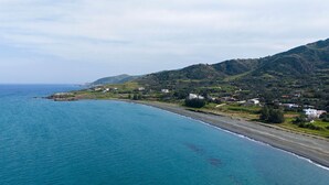 A coastal landscape with a beach, houses, and hills. - Villa Omega | Peaceful Coastal Stay with Sea Views (Polis)