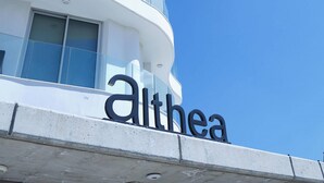 A modern building with a curved facade and the name "Althea" prominently displayed. - Suite 1003 at Althea Residence (Larnaca)