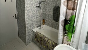 Une salle de bain avec une douche, un lavabo et des toilettes.