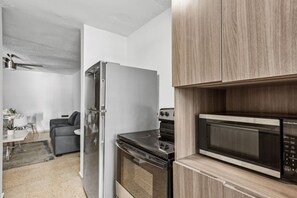 A modern kitchen with a built-in microwave, oven, and refrigerator.