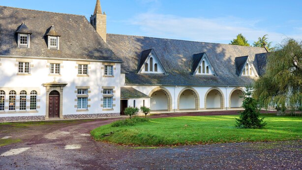 A large building with multiple arched windows and a central entrance.