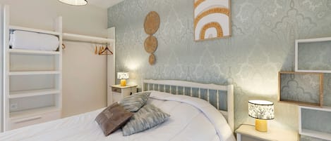 A neatly arranged bedroom with a bed, bedside tables, a wardrobe, and wall decorations.