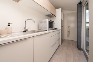 Fridge, microwave, stovetop, coffee/tea maker
