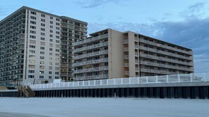 A multi-story hotel with balconies, a pier, and a beach view. - Chic Cozy Condo with Stunning Views (Daytona Beach Shores)