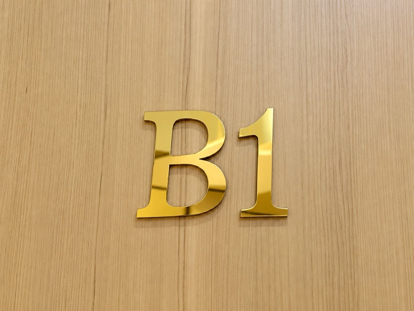 A wooden surface with a gold letter 'B1' embossed on it.