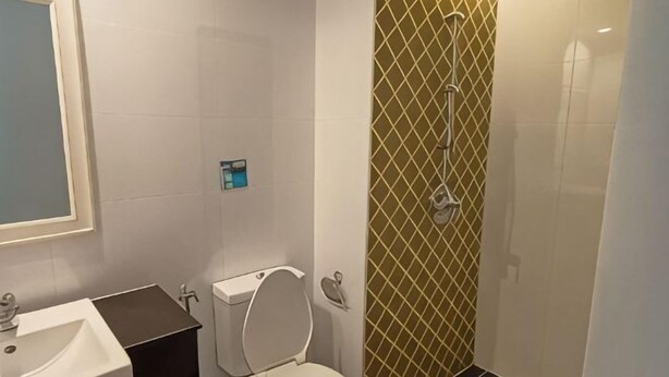 A bathroom with a toilet, sink, and shower. - Slumber Surf Phuket Kata (Phuket)