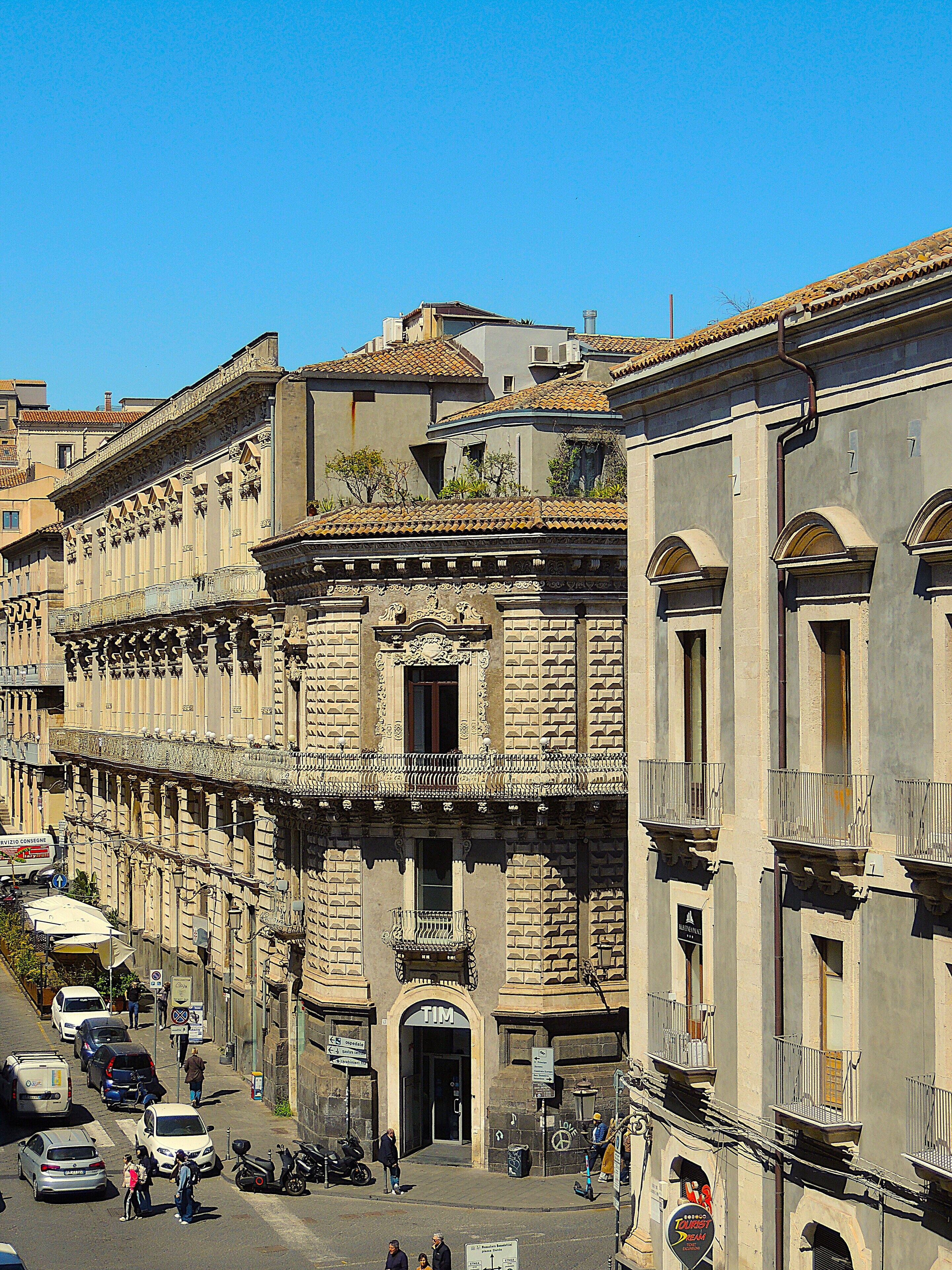 A historic building with a traditional facade, multiple balconies, and a central entrance.