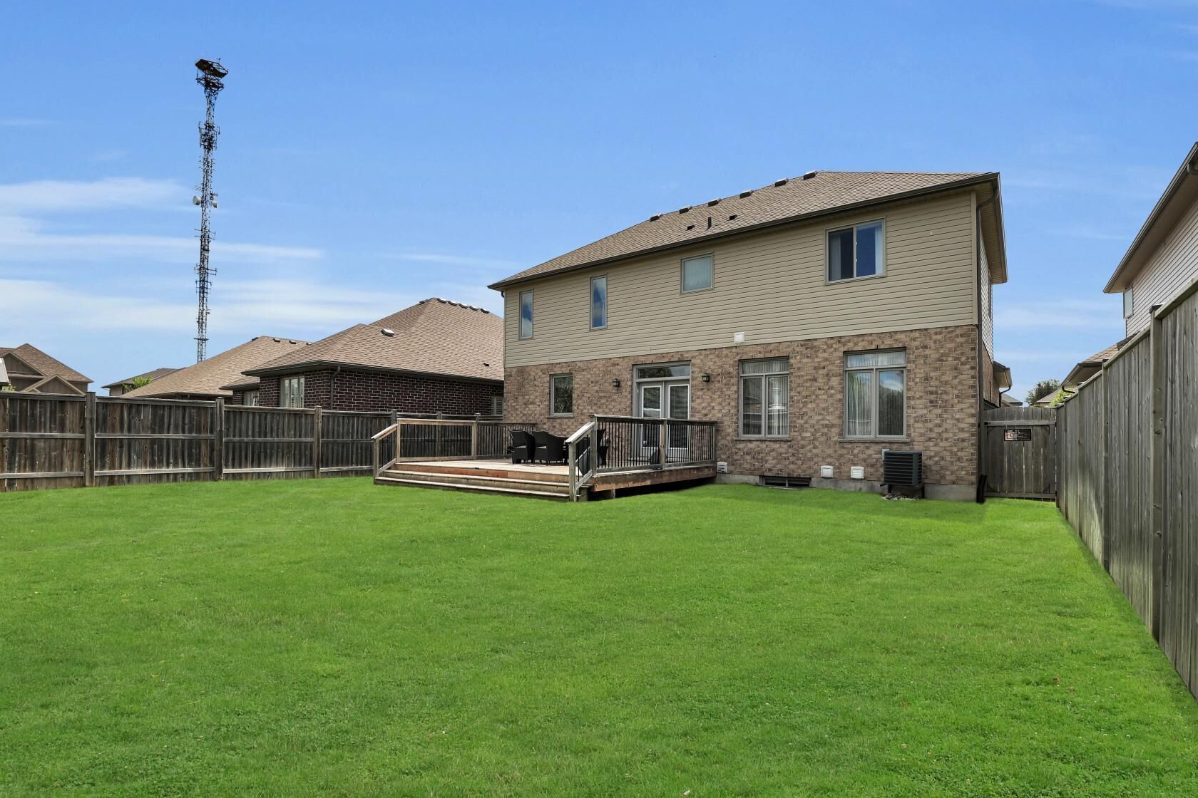 A two-story house with a backyard.