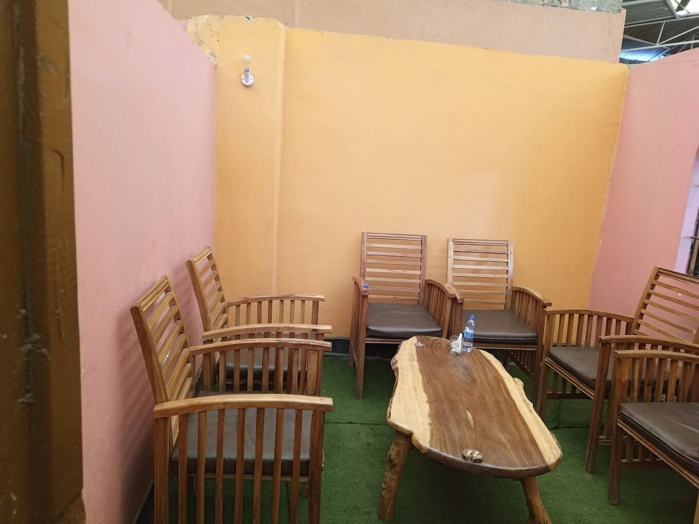 A small, enclosed room with a wooden table and four chairs.