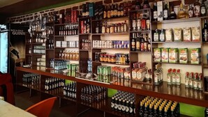 A bar with shelves stocked with various alcoholic beverages, including bottles and cans. - Zuri Resort Bungoma (Bungoma)