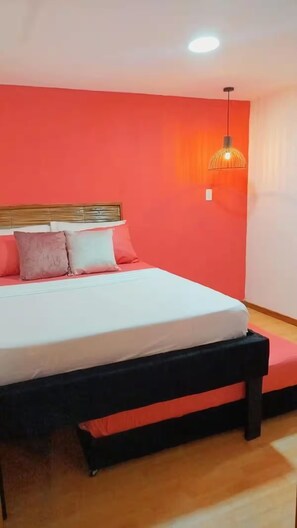 A bedroom with a bed, pillows, a headboard, a hanging light fixture, and a wooden floor. - Hb-m8 House With 8 Bedrooms, Pool AND Near THE SEA (Cartagena)