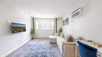 Design Apartment, 2 Bedrooms, Kitchen | Living area | 55-inch LED TV with cable channels