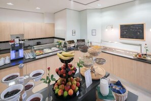 A breakfast buffet with various food items and a coffee machine. - Best Western Hotel Im Forum Muelheim (Mulheim an der Ruhr)