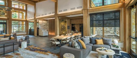 A spacious interior with a large dining area, seating arrangements, and a view through the windows.
