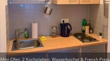 Een koelkast, een oven, een kookplaat, een koffiezetapparaat/waterkoker
