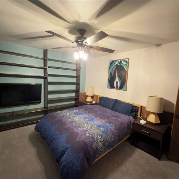 A bedroom with a bed, a ceiling fan, a painting, and a TV on the wall. - Cozy Condo w/Trails out Back w/Hot Tub & Sauna - Near Downtown, FLC & Golfing (Durango)