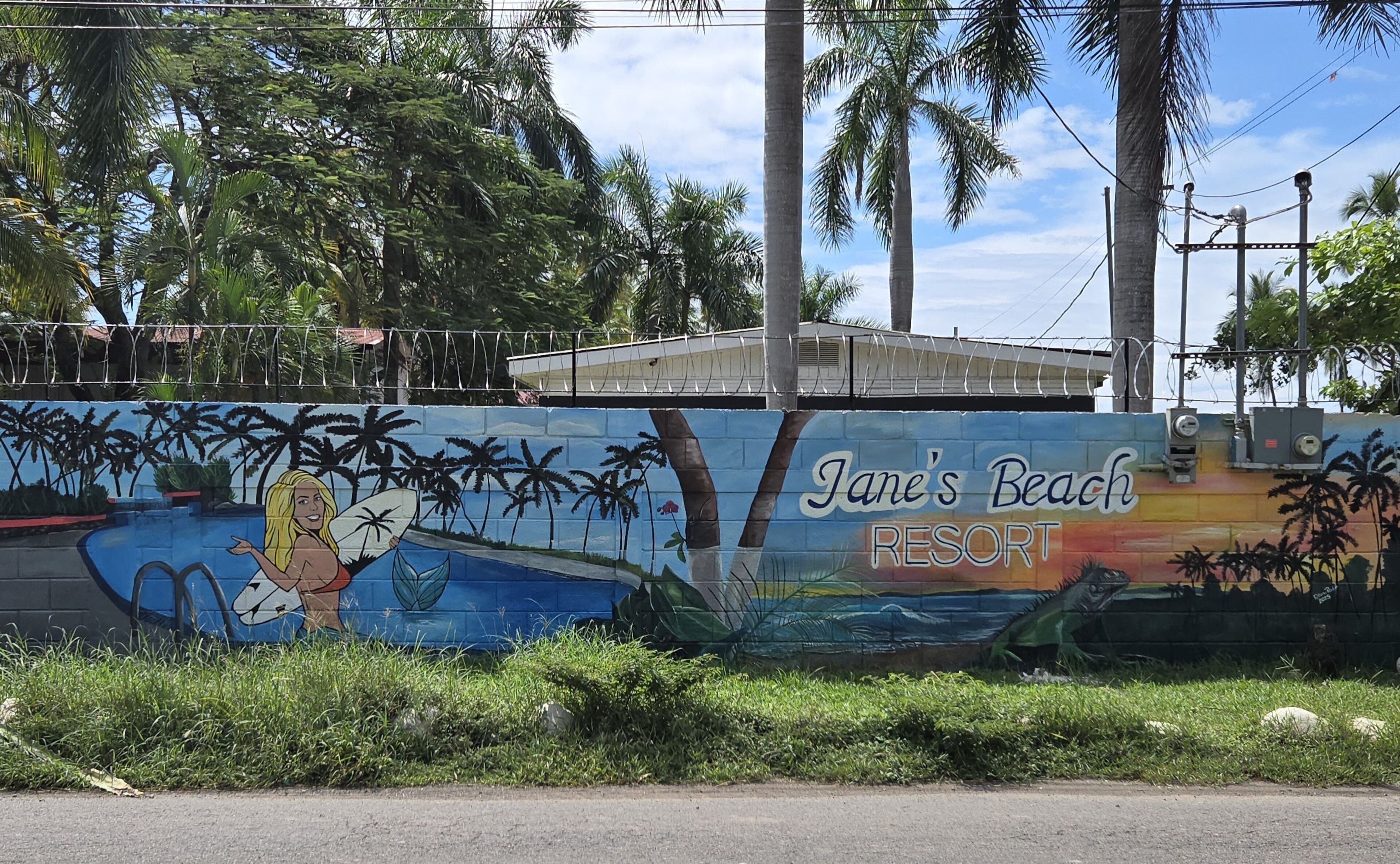 A mural of a woman with a surfboard at Jane's Beach Resort.
