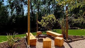 A garden with wooden benches, a fire pit, and a small pond. - BLUE GRASS RANCH - MOBILE HOME YUCCA & JACUZZI (Bischoffsheim)