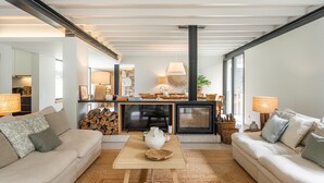 A modern living room with a sofa, coffee table, and fireplace. - Villa 243 - Charming Villa in a peaceful area (Orbacém)