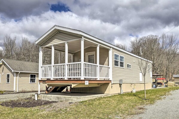 A two-story house with a porch and a covered front porch area.