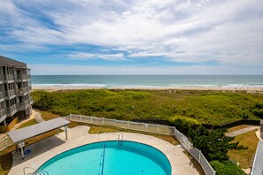 A swimming pool with a view of the beach and ocean. - 3rd-Floor Condo in Oceanfront Building w/Ocean Views, Shared Pool, Free WiFi (Atlantic Beach)