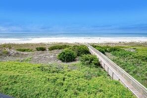 A wooden boardwalk leading to a beach with a clear view of the ocean. - Ocean View Condo on the 2nd Floor with WiFi & Shared Pools/Hot Tub/Putt-Putt (Atlantic Beach)