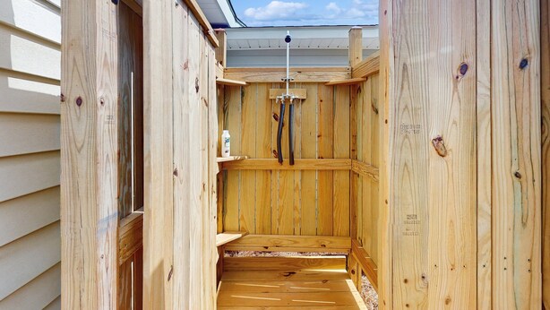 A wooden sauna with a sloped ceiling and a wooden bench.
