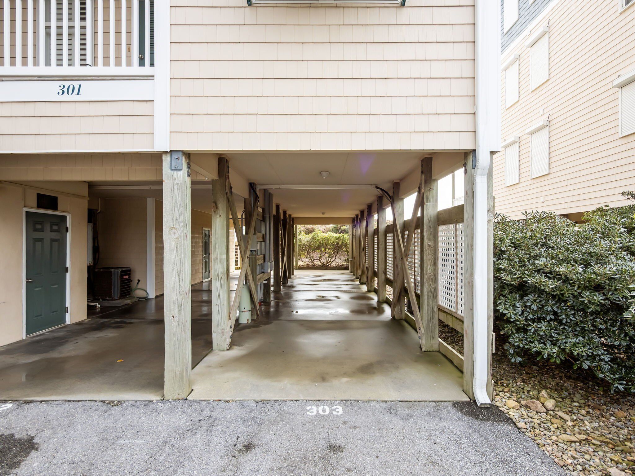 A covered walkway between buildings with a number '301' above one entrance.