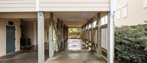 A covered walkway between buildings with a number '301' above one entrance.