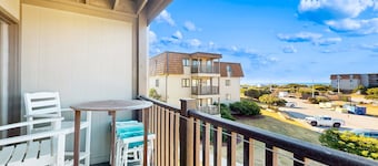 Charming ocean view condo with open layout, balcony, pool, W/D, AC, & internet