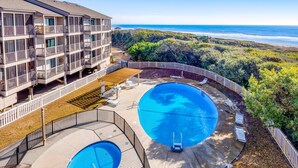 A hotel with a large pool, multiple balconies, and a view of the ocean. - 3rd Floor Oceanfront Condo w/Great Ocean and Pool Views and Shared Pools (Atlantic Beach)