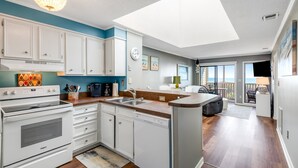 A modern kitchen with white cabinets, a built-in oven, and a dishwasher. - 3rd Floor Oceanfront Condo w/Great Ocean and Pool Views and Shared Pools (Atlantic Beach)
