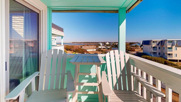 A balcony with a view of a beach and buildings. - Condo with on-site beach access, pools, grill/picnic areas, & private balcony (Atlantic Beach)