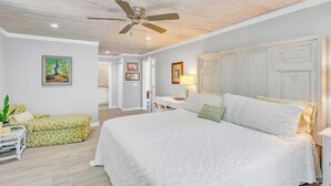 A bedroom with a large bed, a ceiling fan, and a desk with a lamp. - 3-bedroom waterfront house in fabulous Cudjoe Key (Cudjoe Key)